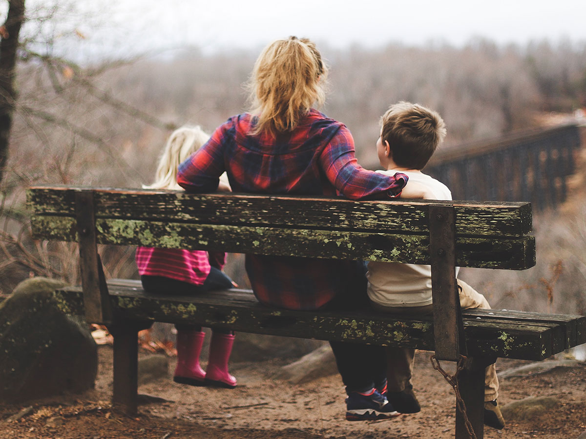 Woman and children sitting on a bench