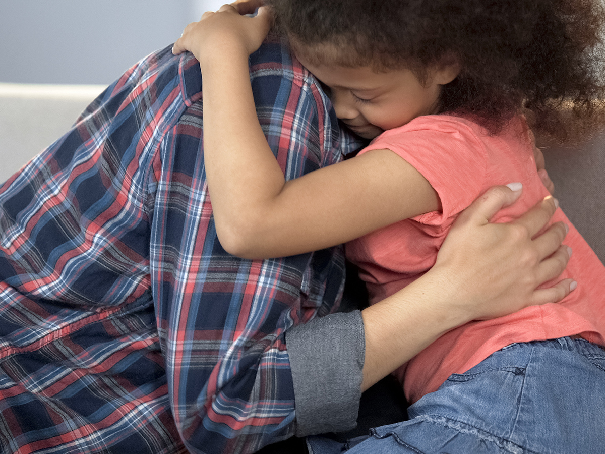 Child hugging an adult