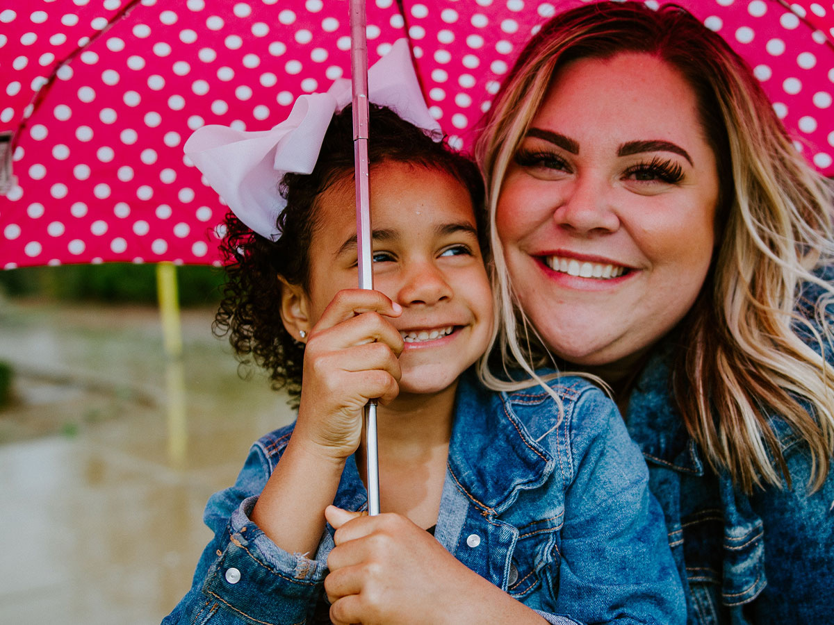 Woman and child under an umbrella