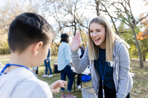 Volunteer high-fiving child