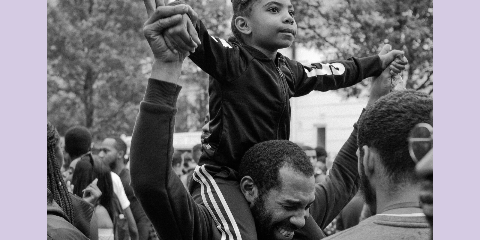 man with child on shoulders