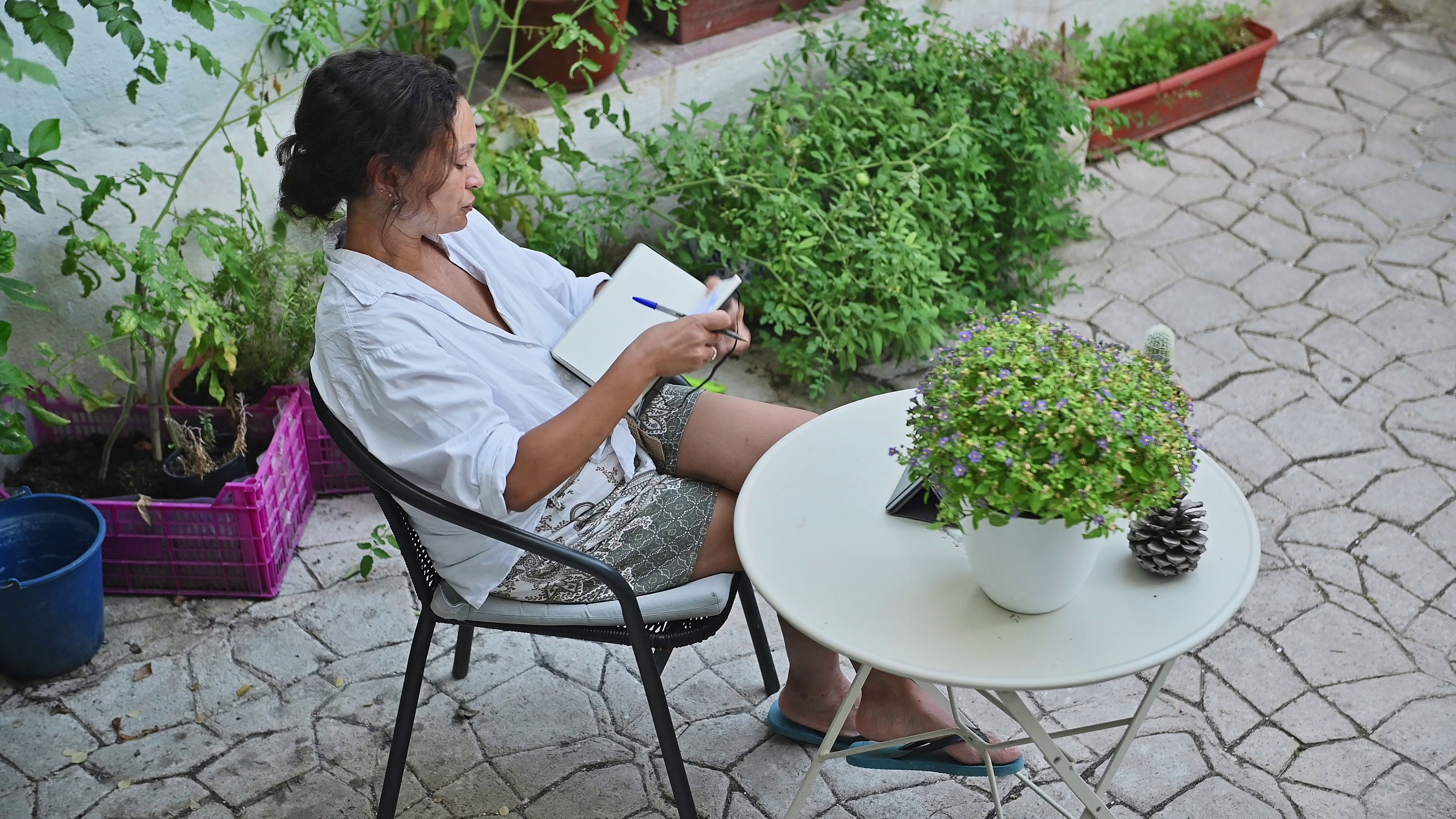 Woman journaling in a garden