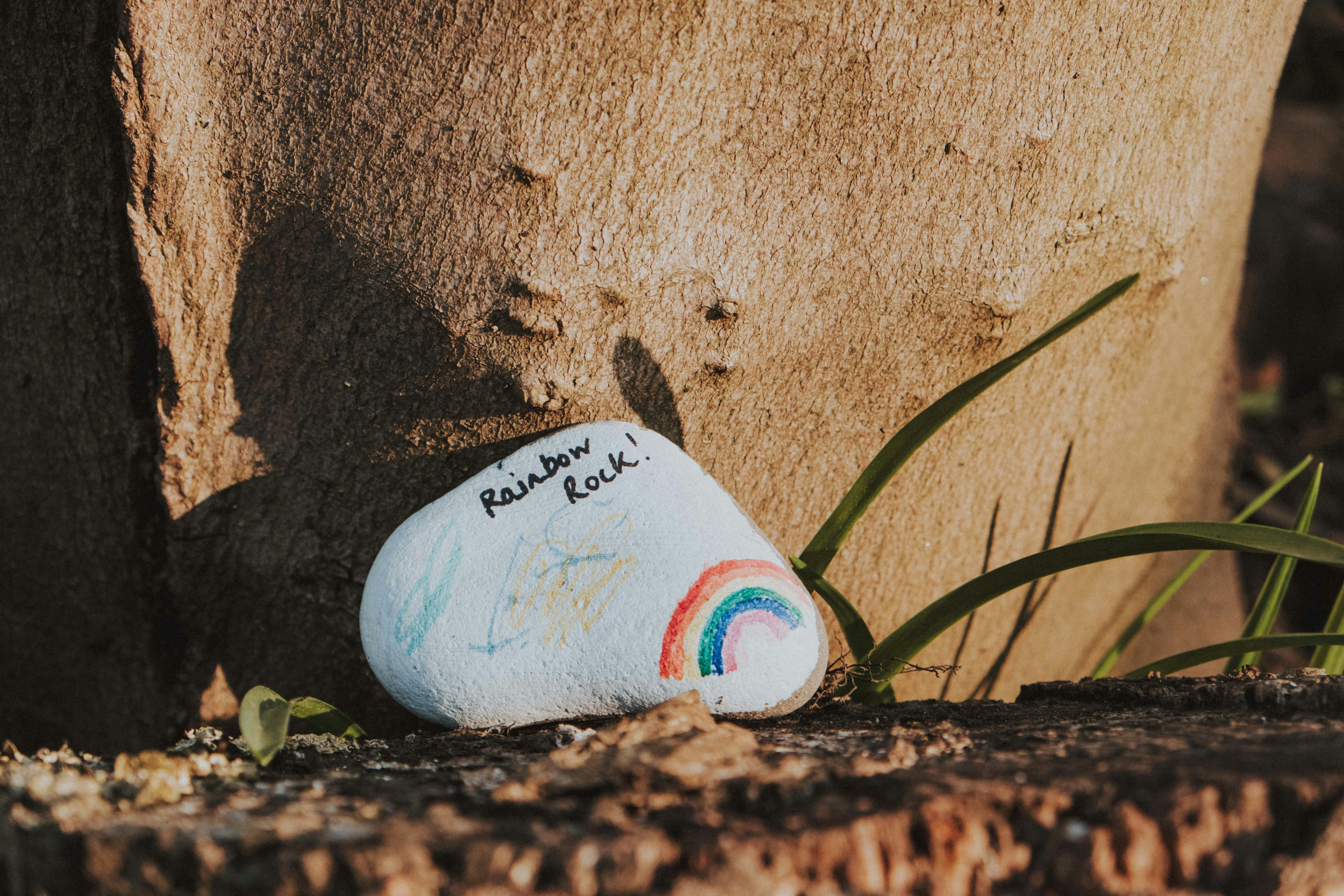 rock painted with inspirational rainbow