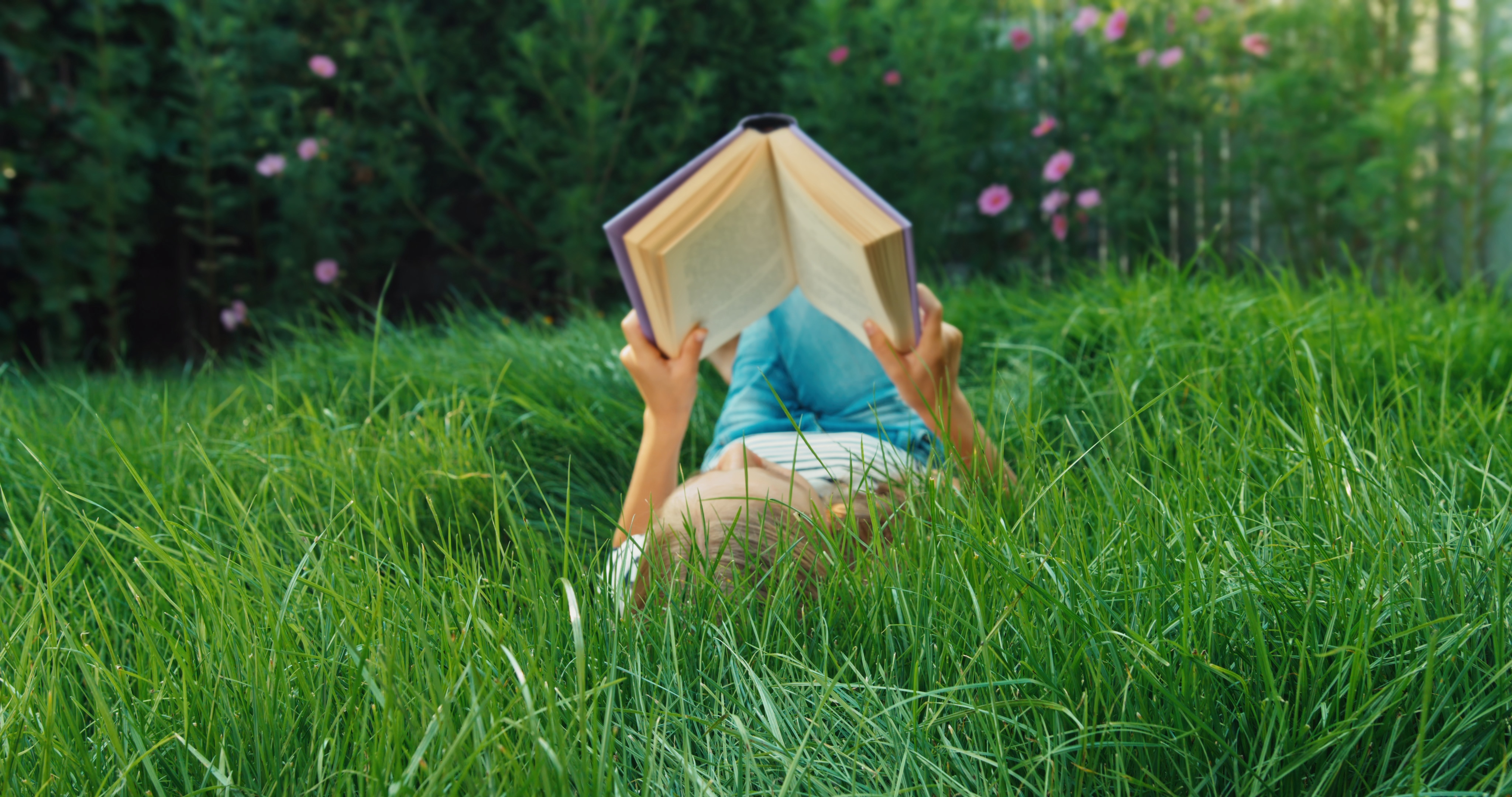 girl with book in the grass