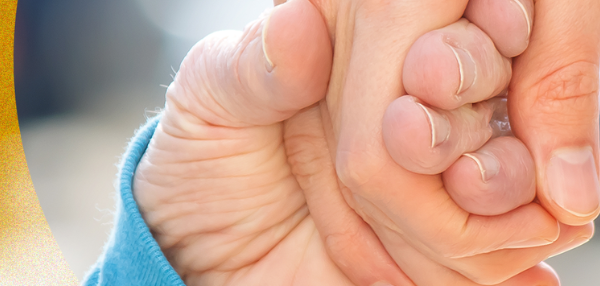 child and adult holding hands