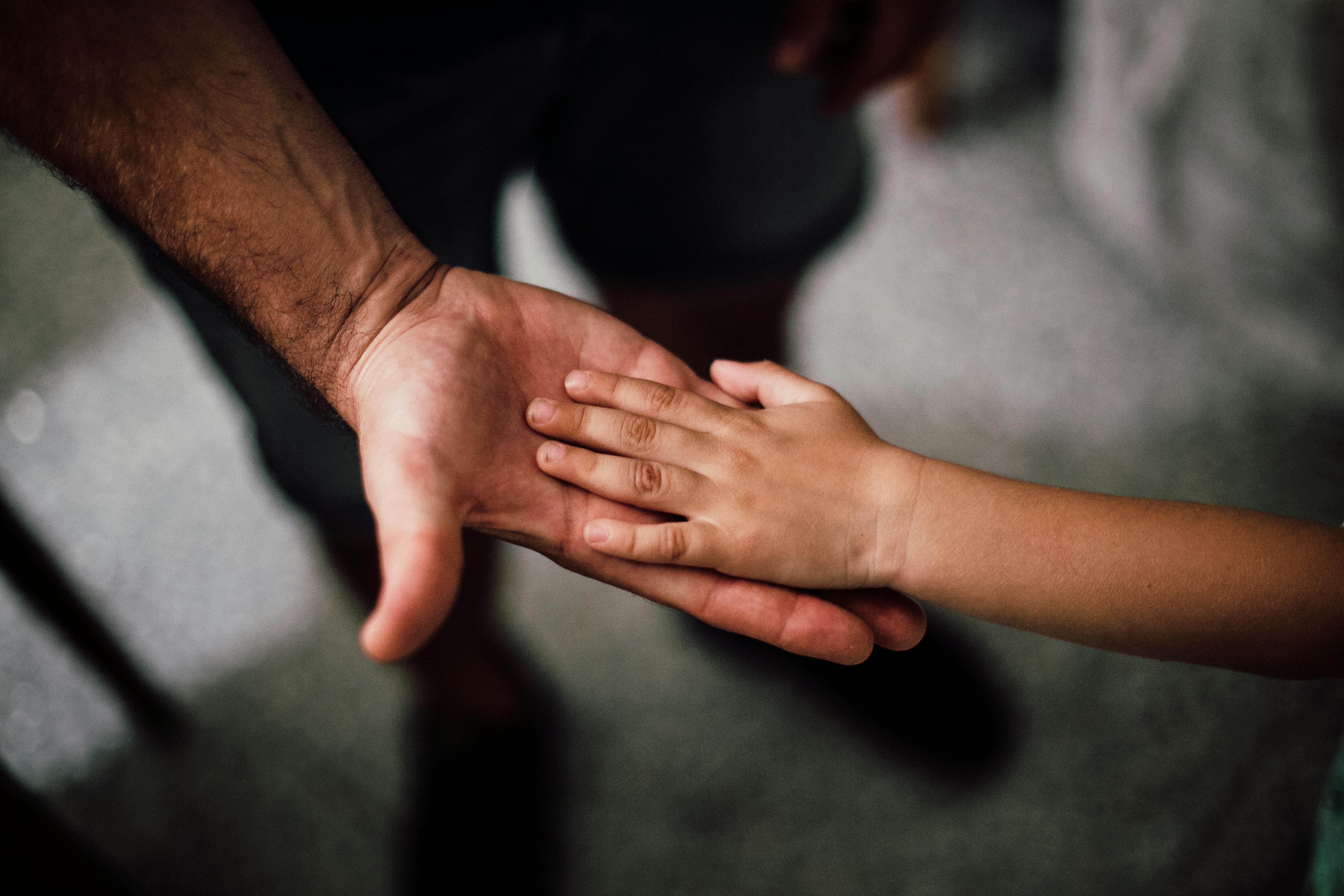 Child's hand on father's hand