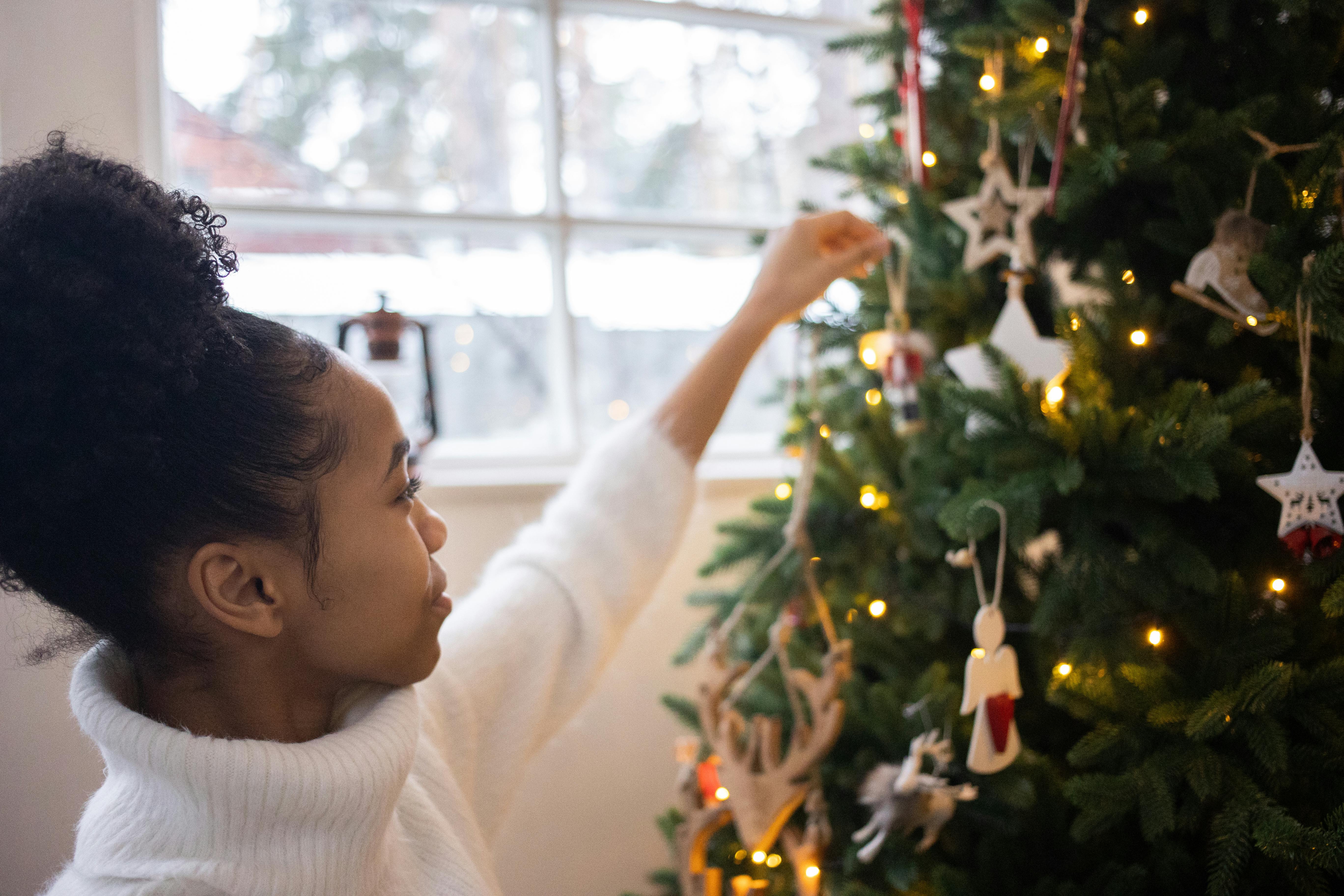 Girl decorating a Christmas tree