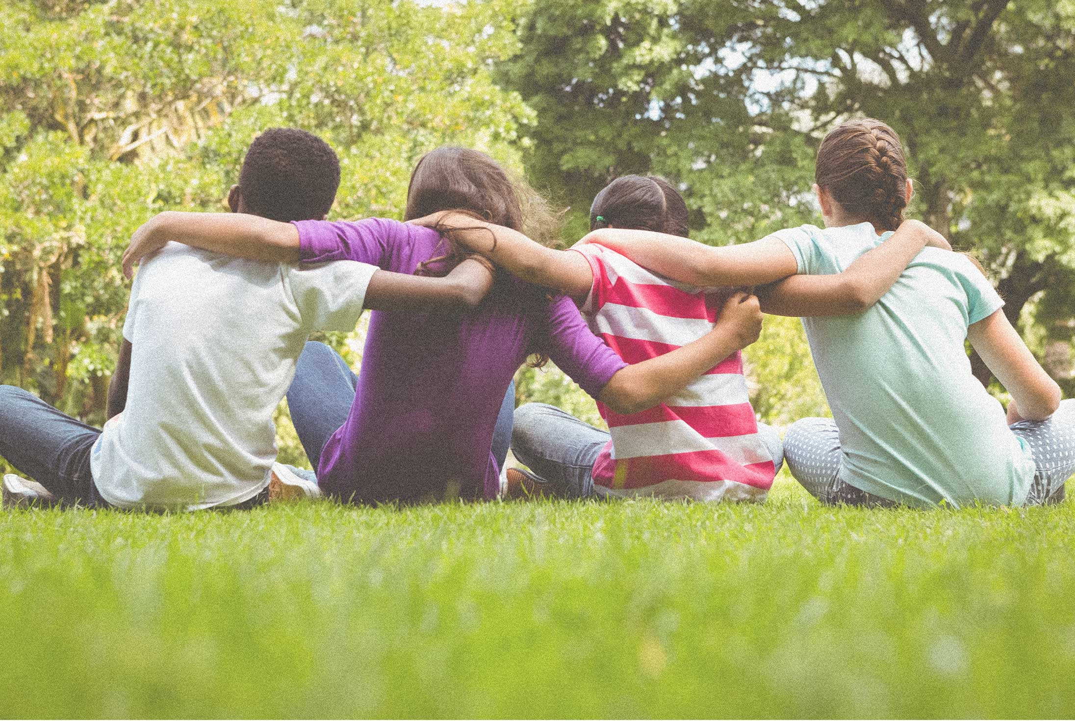Group of people with arms around each other