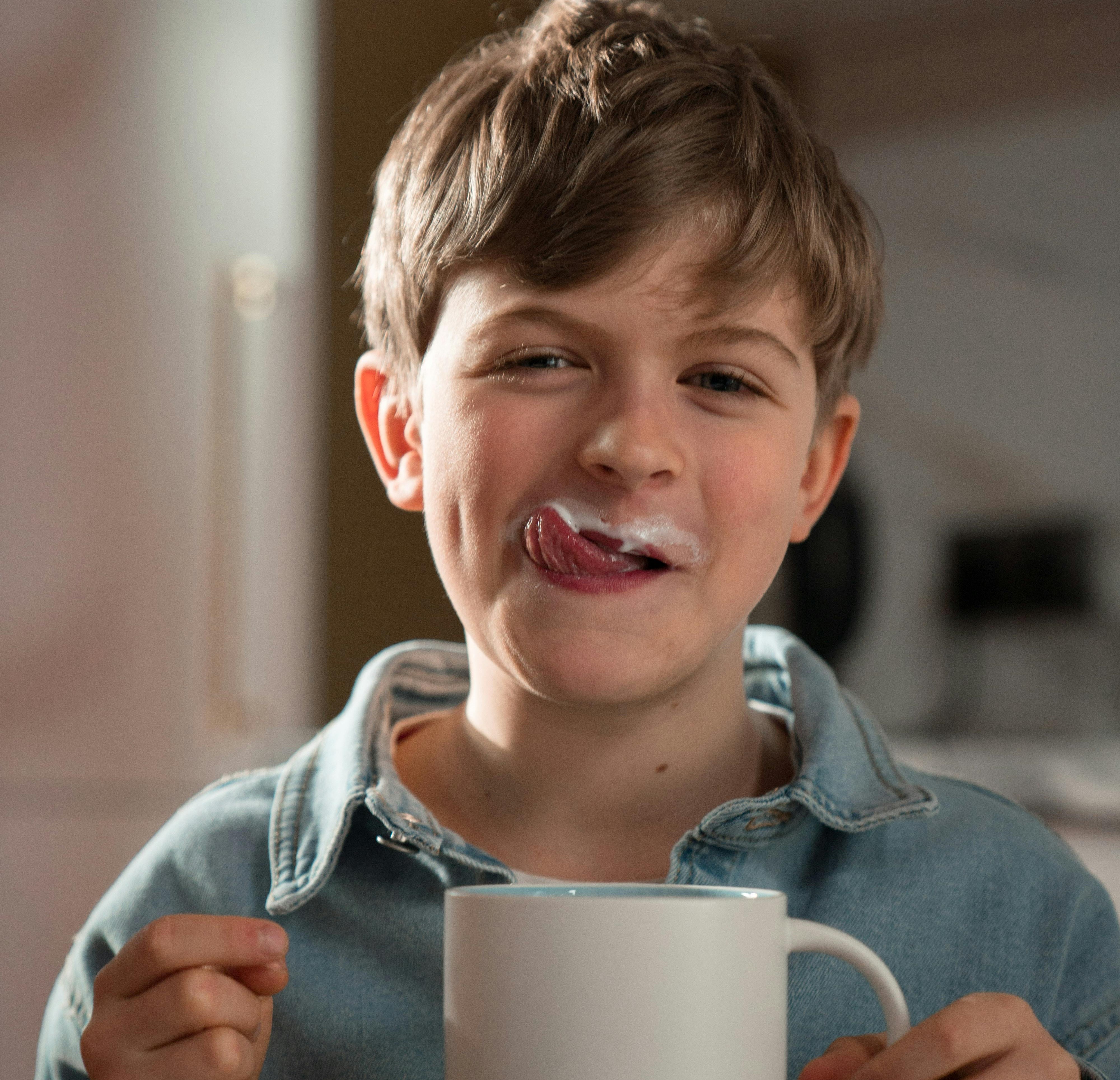 boy drinking milk with a messy face