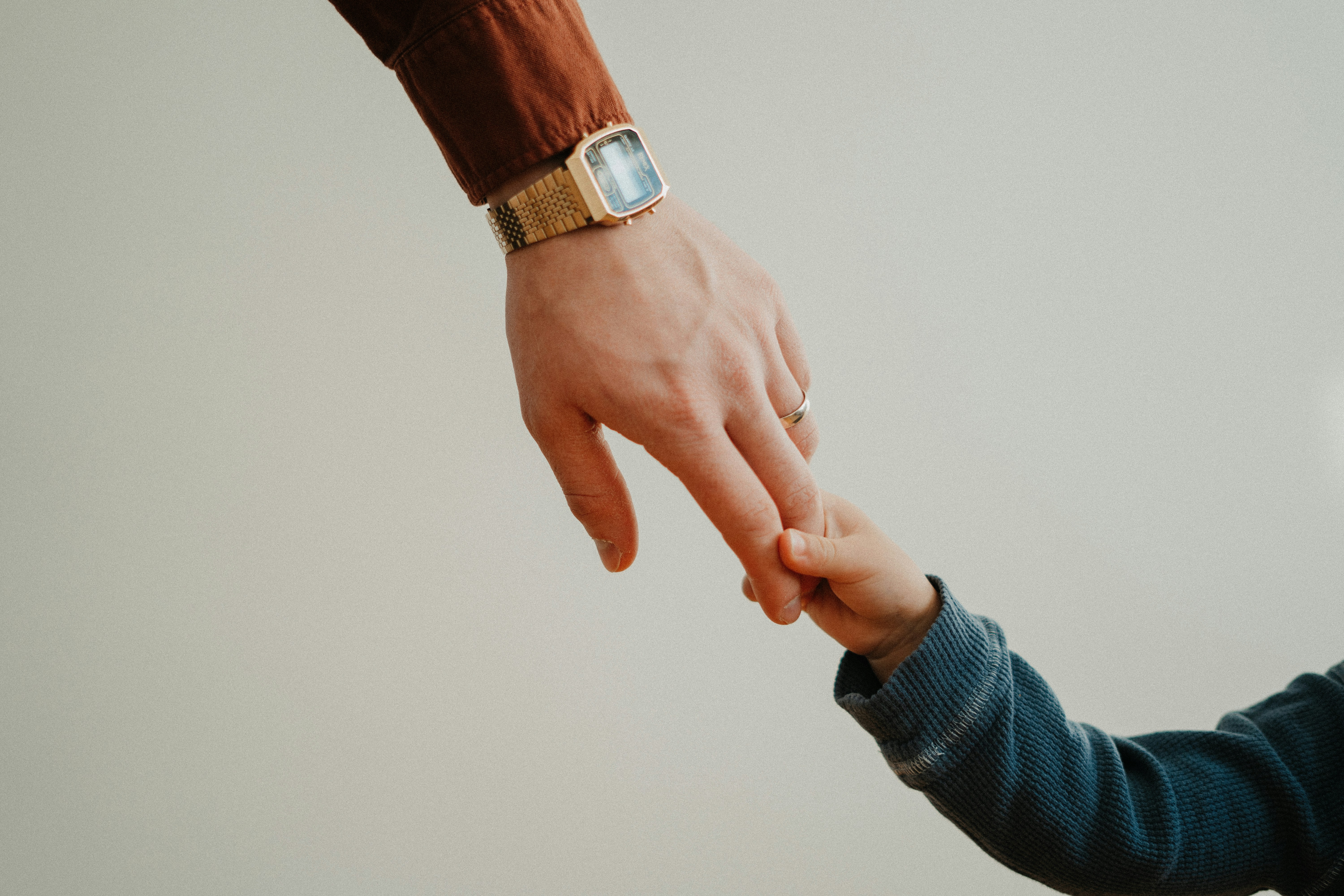 Father and child holding hands
