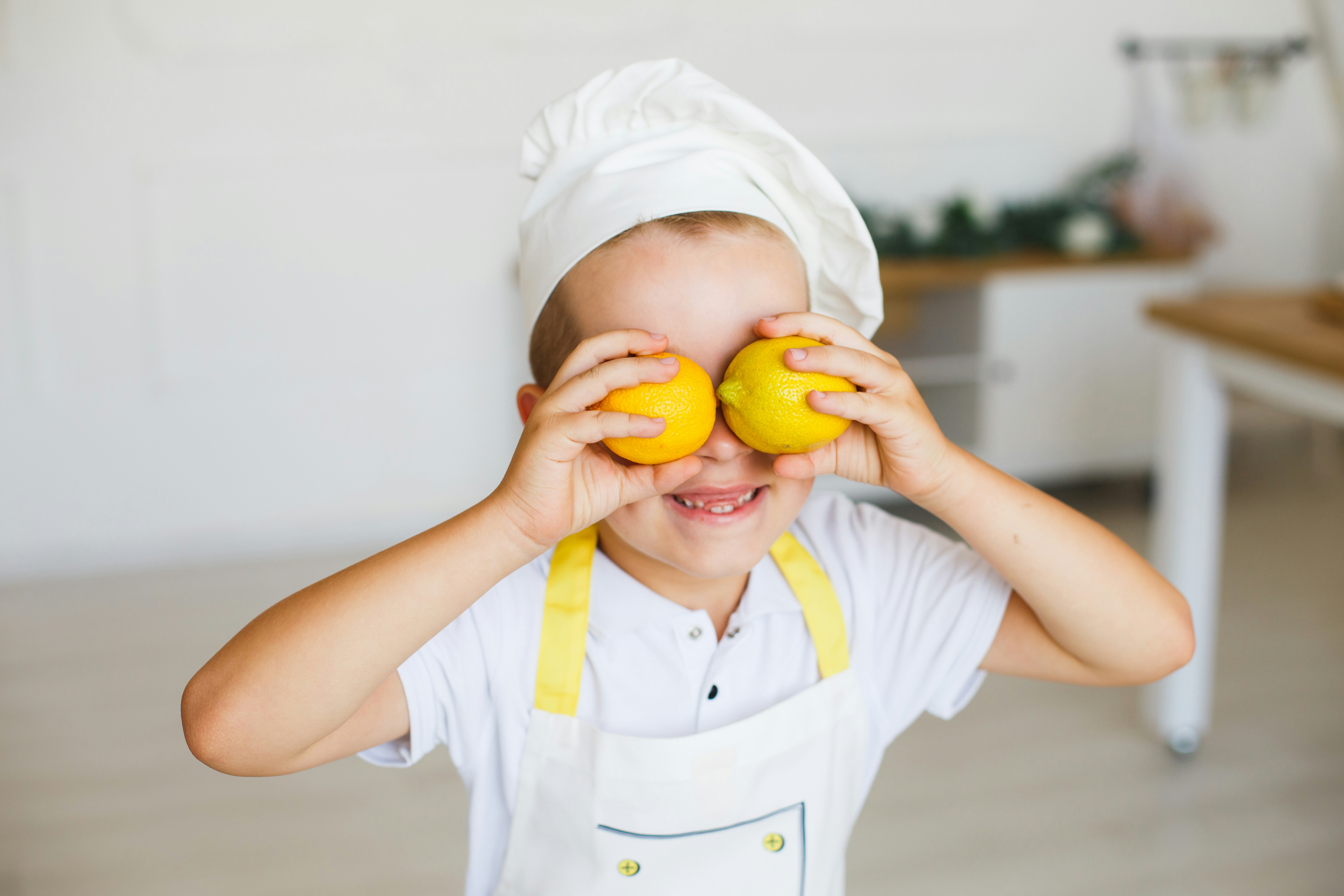 child with lemons on his eyes