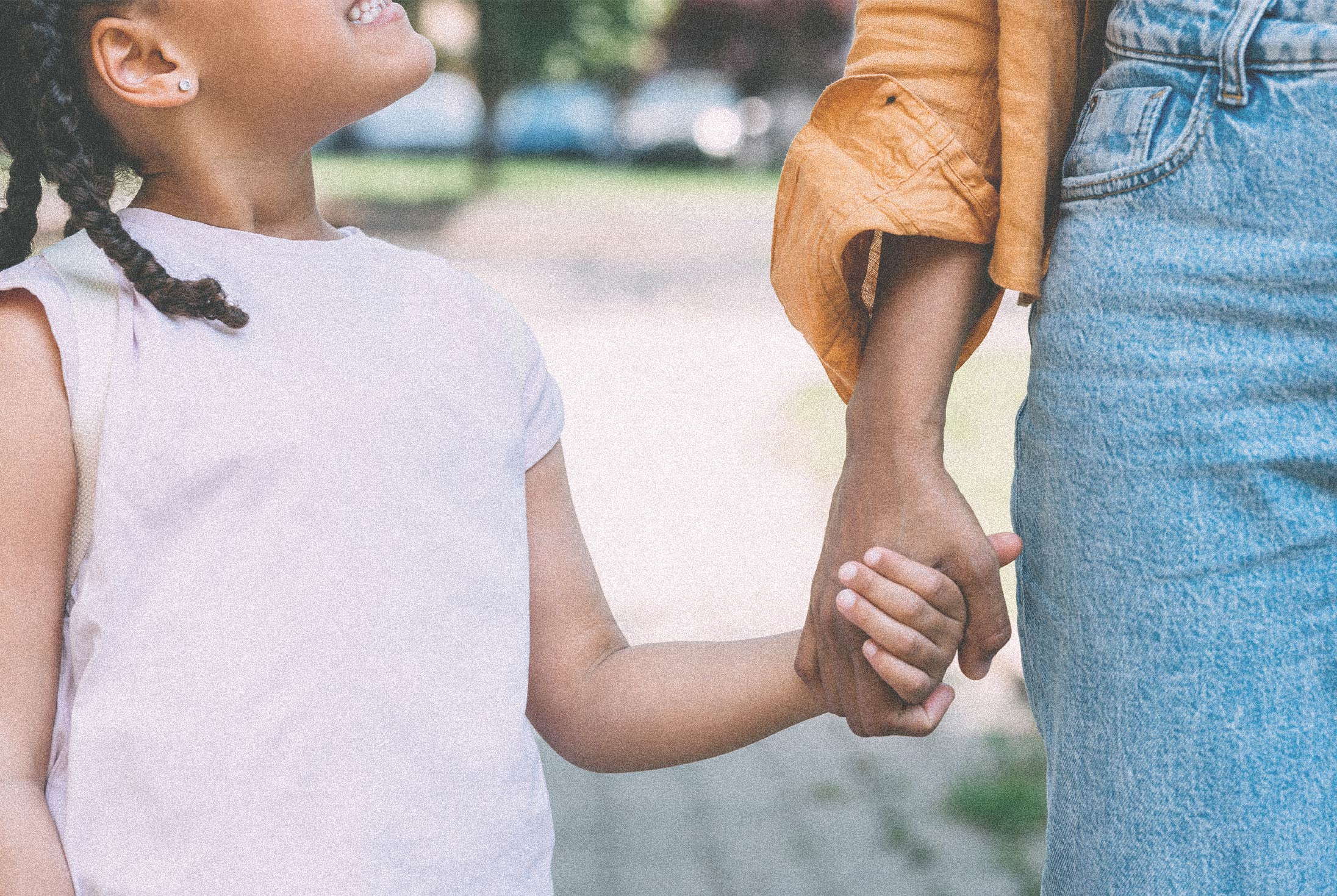 Child holding the hand of an adult