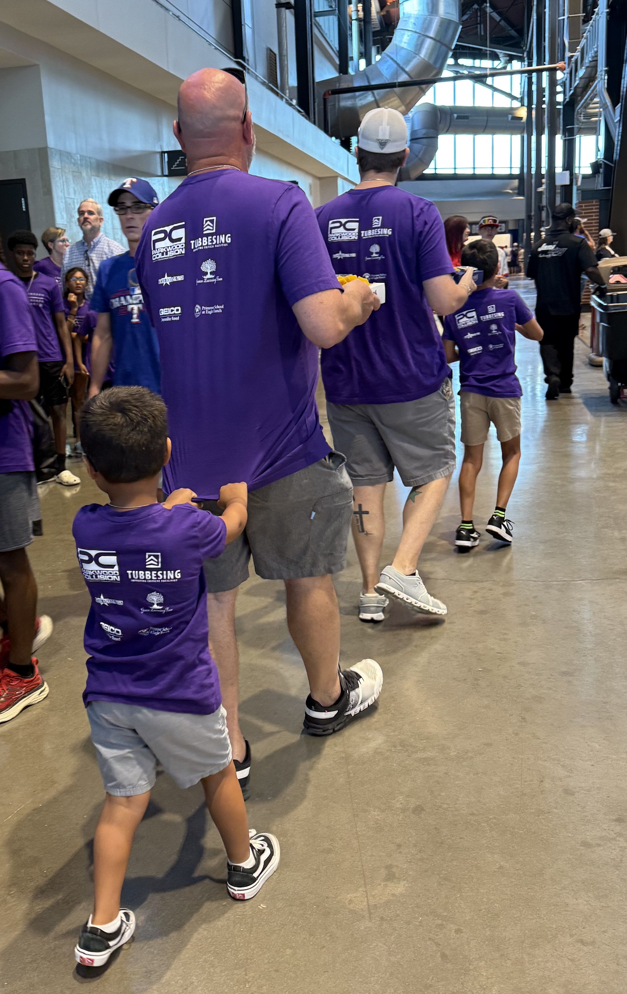 boys and dads walking through the stadium