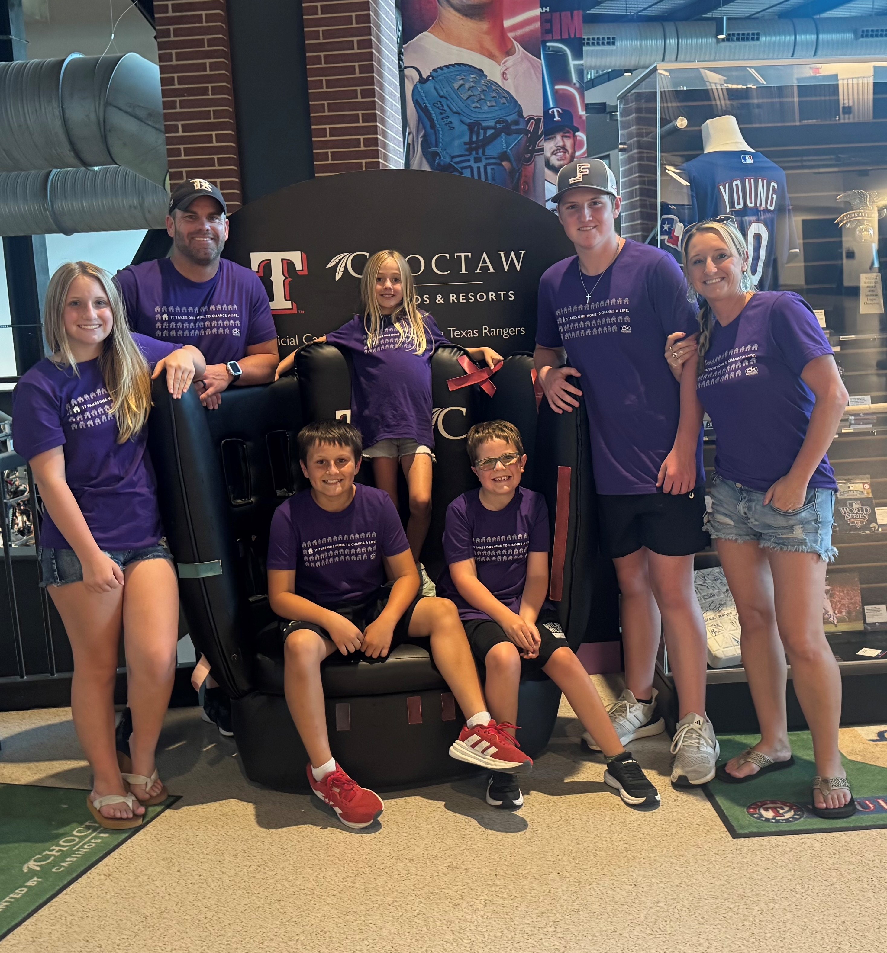 family at the Texas Rangers game in purple shirts