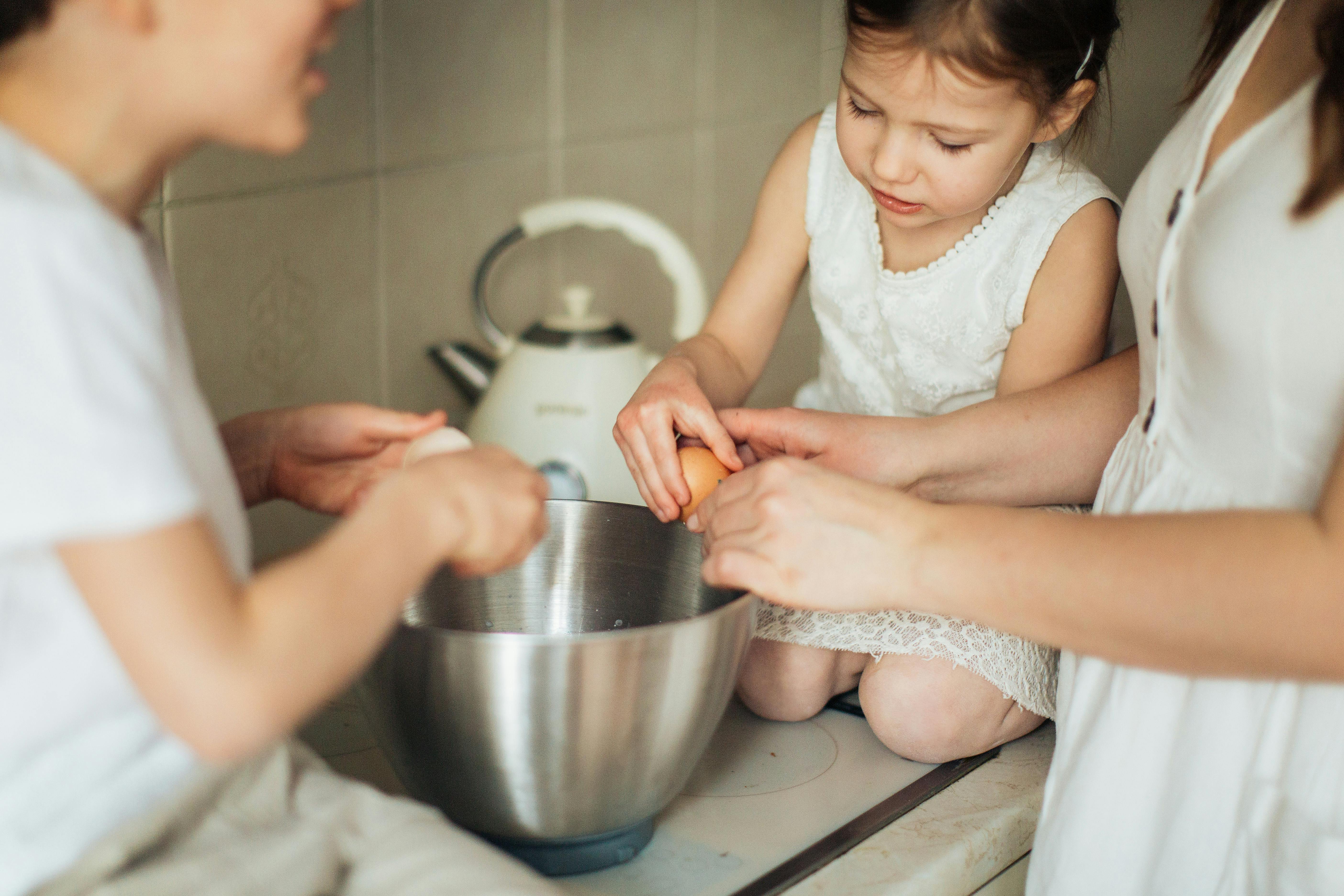 child cracking an egg