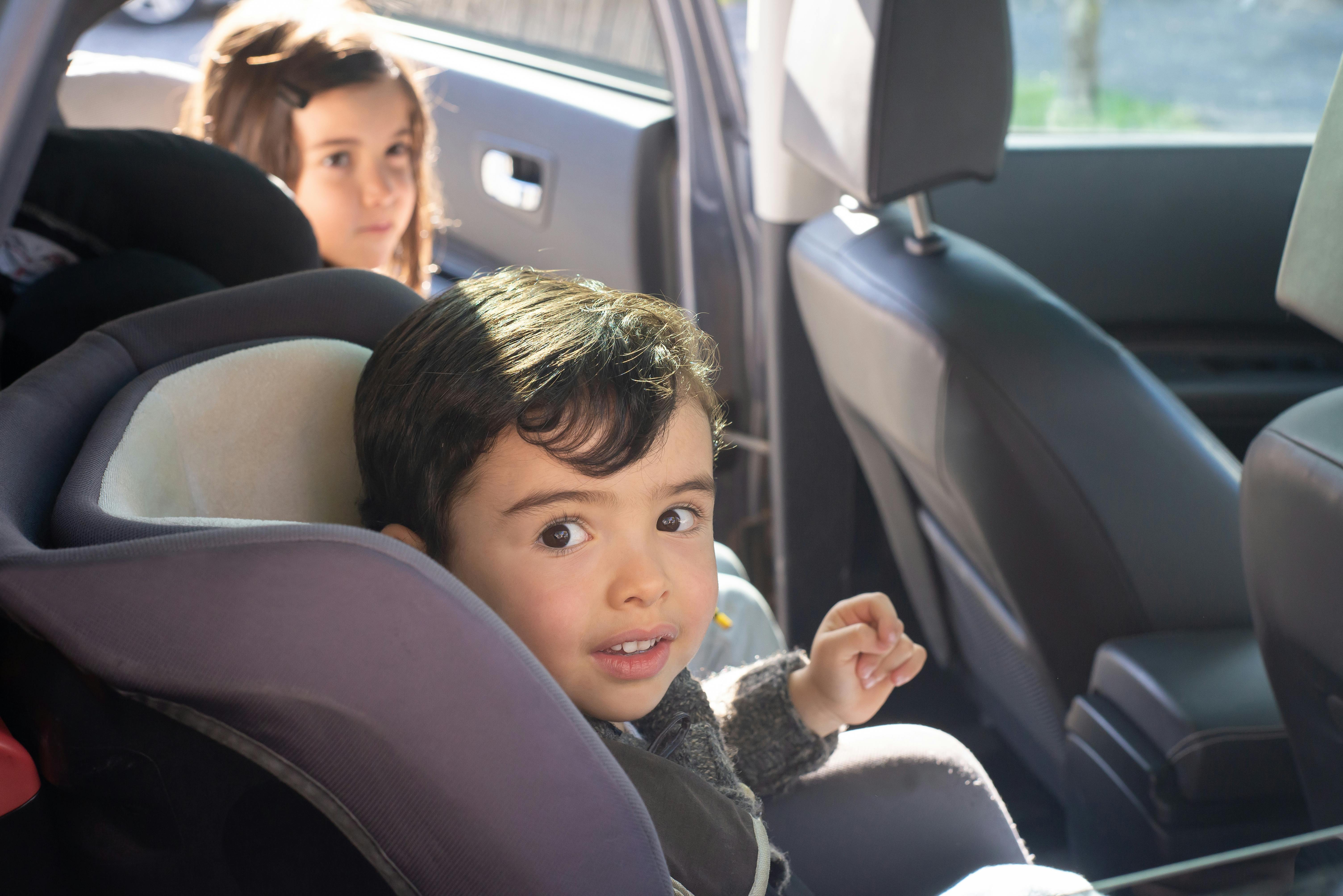 children in car seats in a car