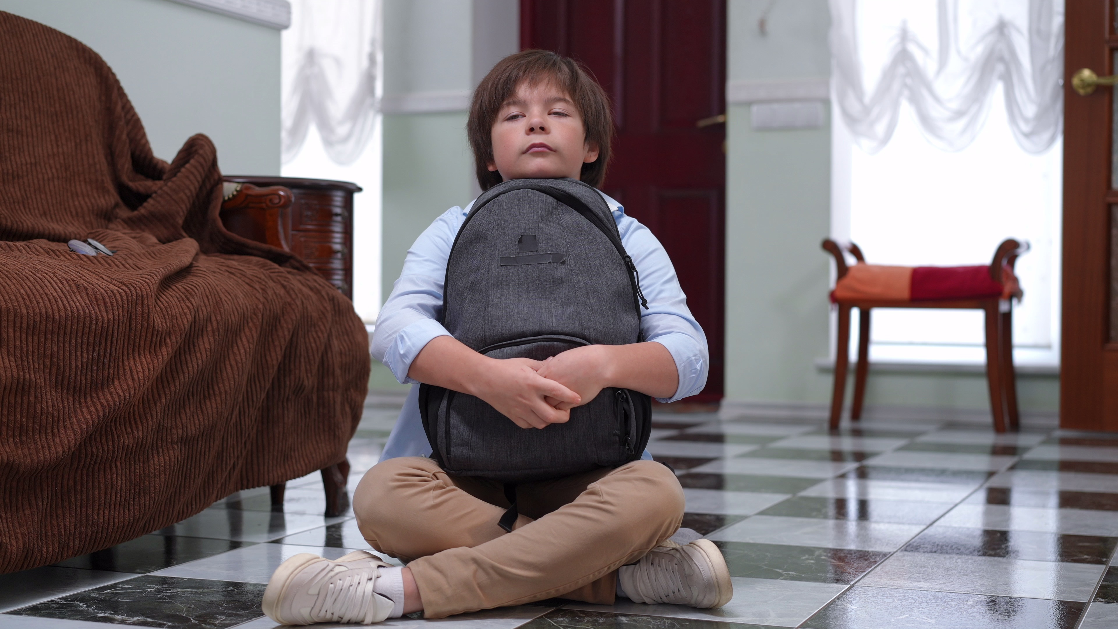 anxious child holding backpack