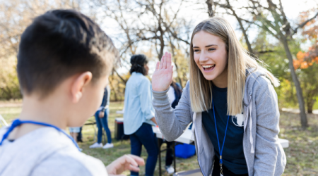 Volunteer high-fiving child