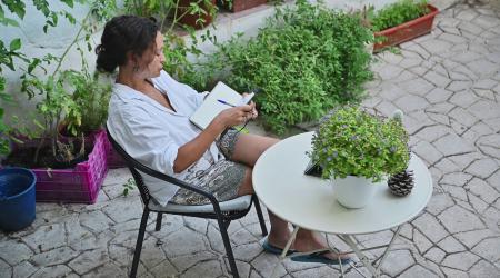 Woman journaling in a garden