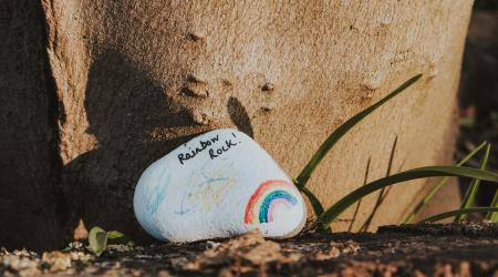 rock painted with inspirational rainbow