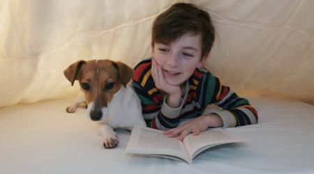 boy reading with his dog