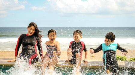 mother with children next to the pool