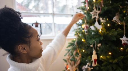 Girl decorating a Christmas tree