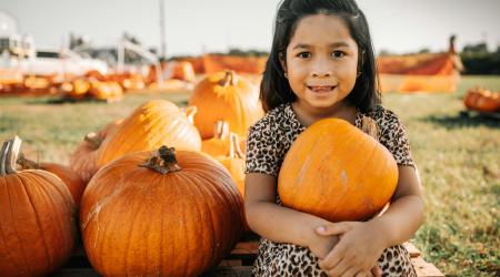 Little girl in pumpkin patch