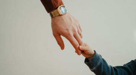 Father and child holding hands