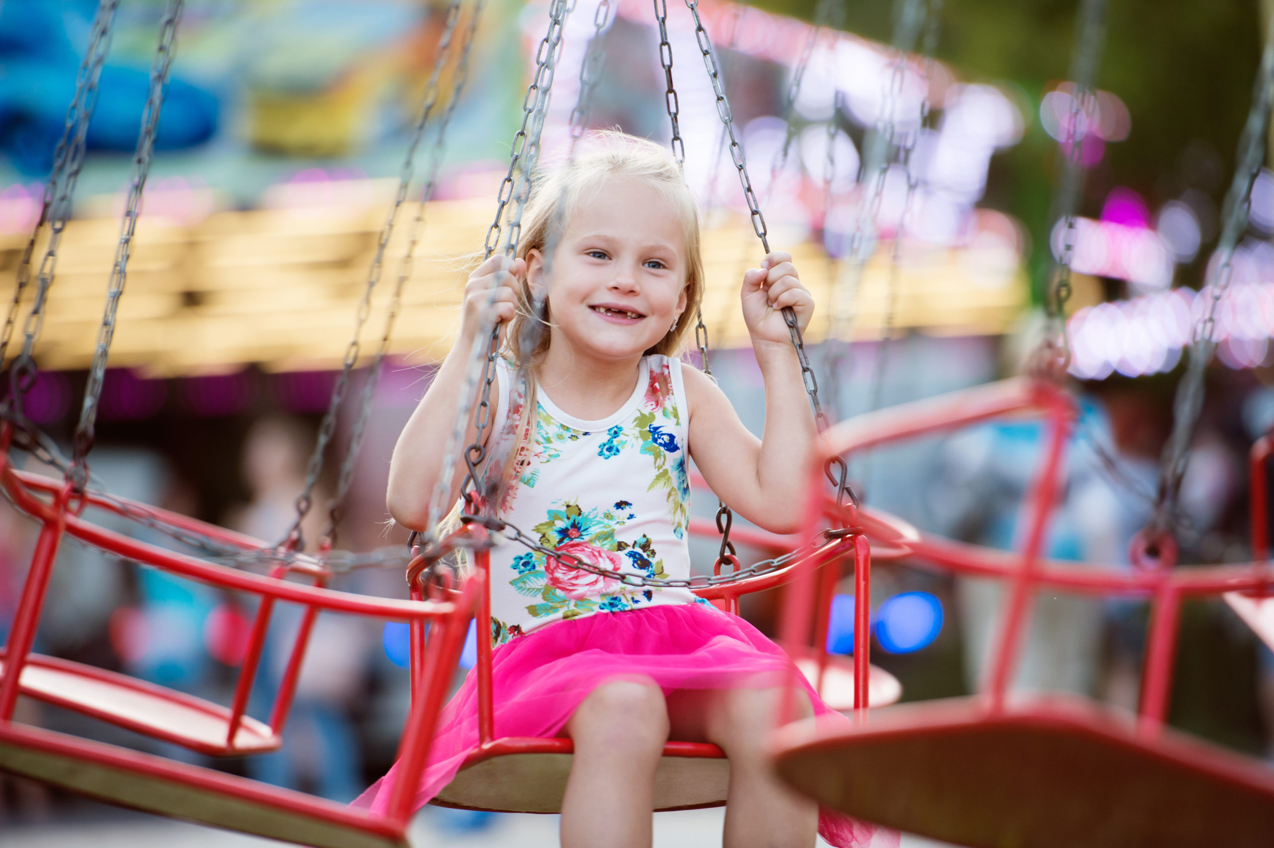 little girl on swing at fair