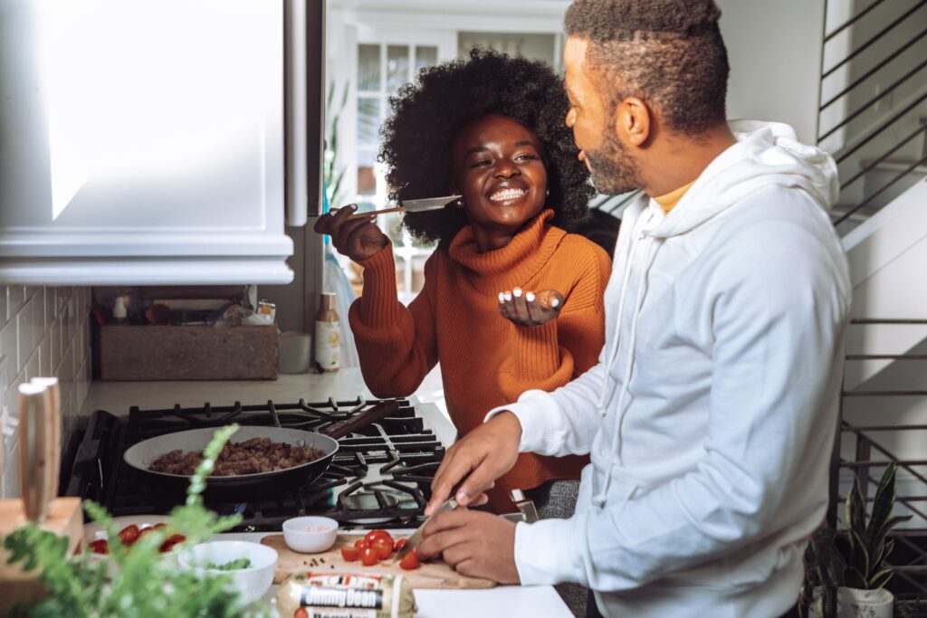 black couple cooking together